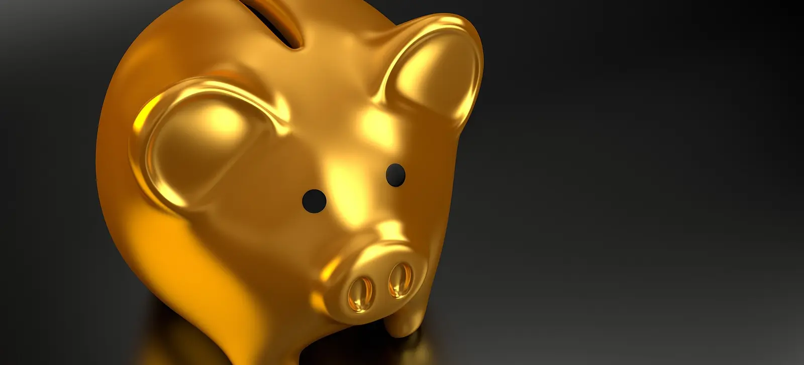 Golden piggy bank on a dark background